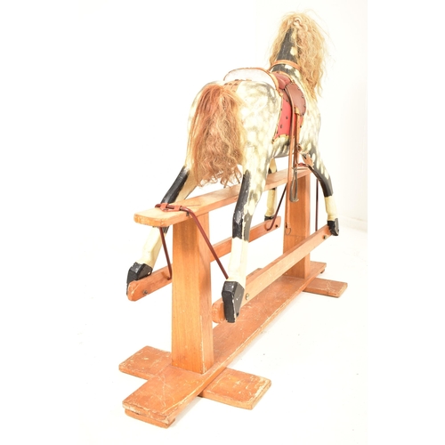 314 - A 1920's carved wood hand painted rocking horse on swing base in the manner of Line Brothers. The ho... 