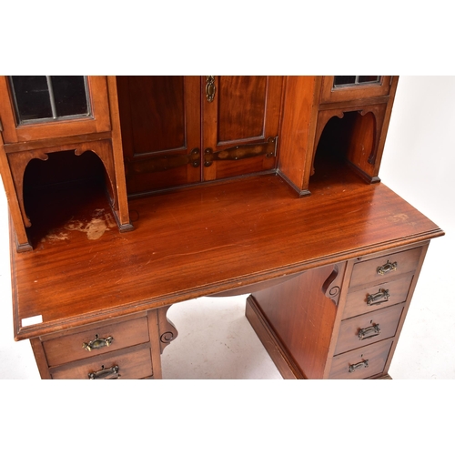 507 - An Arts & Crafts Edwardian mahogany twin pedestal desk cabinet. The cabinet having twin lead coloure... 