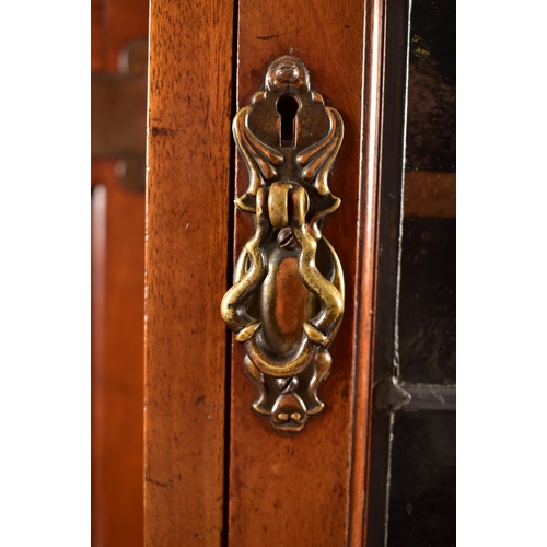 507 - An Arts & Crafts Edwardian mahogany twin pedestal desk cabinet. The cabinet having twin lead coloure... 