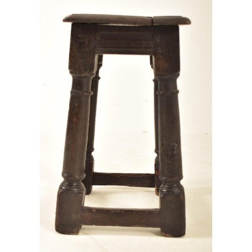 511 - An 18th century carved oak peg jointed low stool. The stool having a chamfered edge squared top over... 