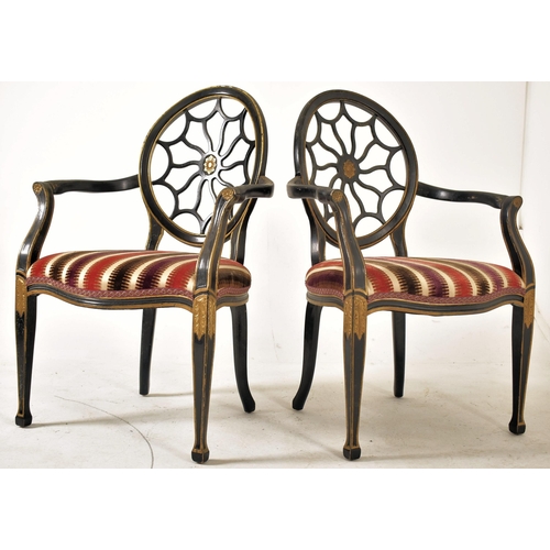 325 - A pair of Regency Revival ebonised & gilt painted spider web back armchairs. Each chair having a bal... 