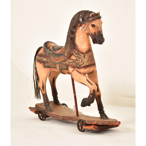 332 - A likely continental carved wood carousel horse adapted to a pull-a-long toy. The horse hand painted... 