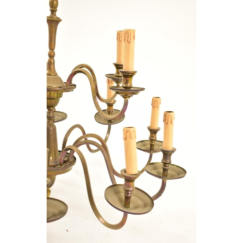 522 - A French manner 20th century brass ten arm two tier chandelier. The chandelier having a central fini... 