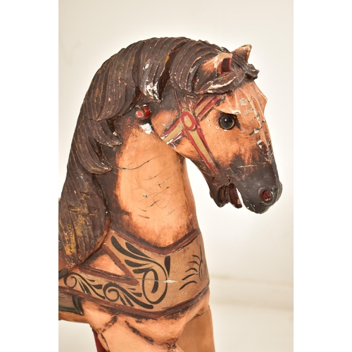 332 - A likely continental carved wood carousel horse adapted to a pull-a-long toy. The horse hand painted... 