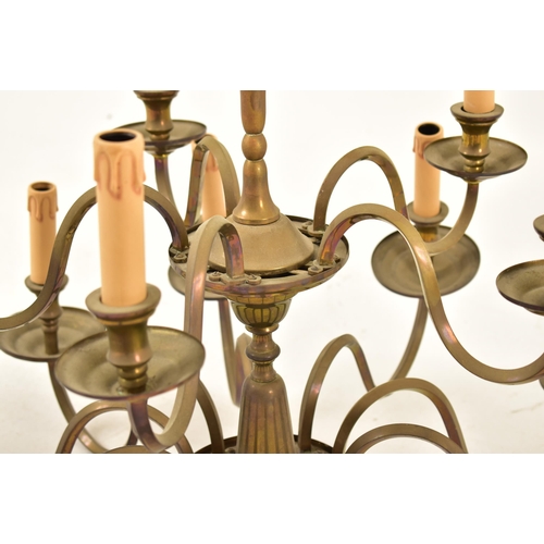 522 - A French manner 20th century brass ten arm two tier chandelier. The chandelier having a central fini... 