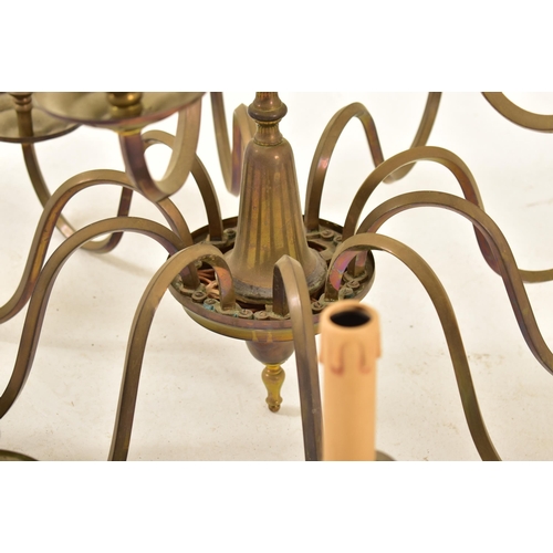 522 - A French manner 20th century brass ten arm two tier chandelier. The chandelier having a central fini... 