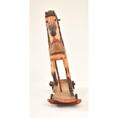 332 - A likely continental carved wood carousel horse adapted to a pull-a-long toy. The horse hand painted... 