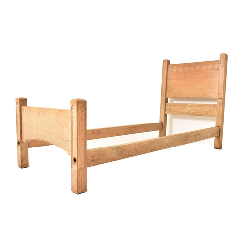 337 - Heal & Son, Ltd - A pair of Arts & Crafts early 20th century carved oak single beds. Each bed includ... 