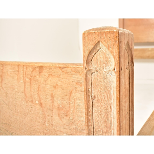 337 - Heal & Son, Ltd - A pair of Arts & Crafts early 20th century carved oak single beds. Each bed includ... 