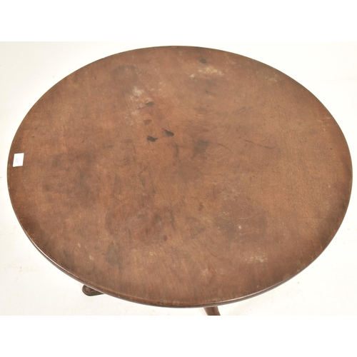 533 - A George III 18th century mahogany tilt top tripod table. The table having a circular hinged tilt to... 