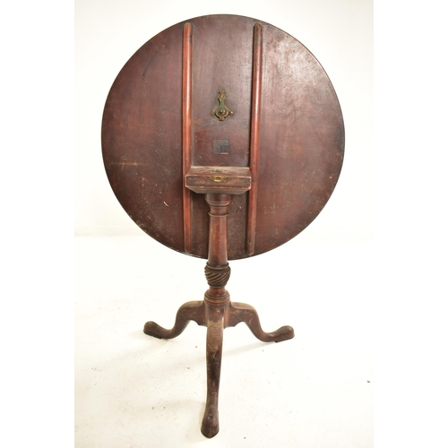 533 - A George III 18th century mahogany tilt top tripod table. The table having a circular hinged tilt to... 