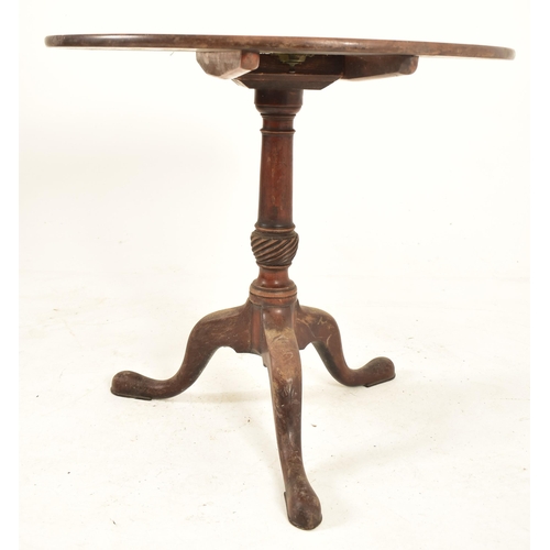 533 - A George III 18th century mahogany tilt top tripod table. The table having a circular hinged tilt to... 