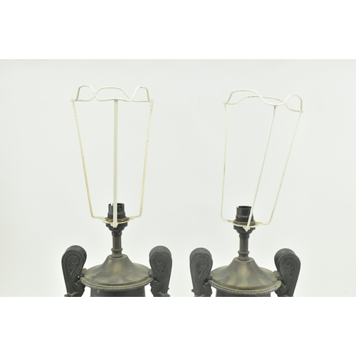 340 - A pair of Neoclassical style metal amphora urn shaped desk table lamps. Each lamp having a flared ne... 