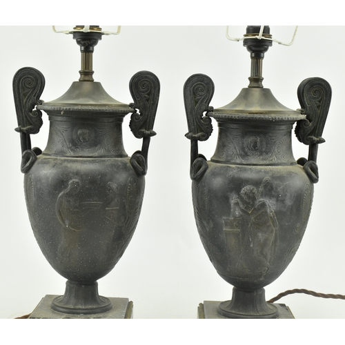 340 - A pair of Neoclassical style metal amphora urn shaped desk table lamps. Each lamp having a flared ne... 