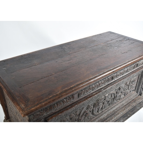 539 - A 16th century carved Italian large Cassone converted to a desk. The heavily carved front panel in r... 