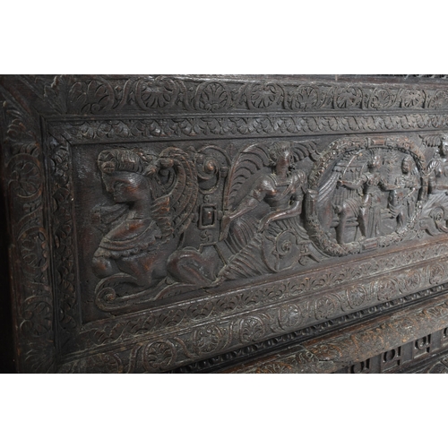 539 - A 16th century carved Italian large Cassone converted to a desk. The heavily carved front panel in r... 