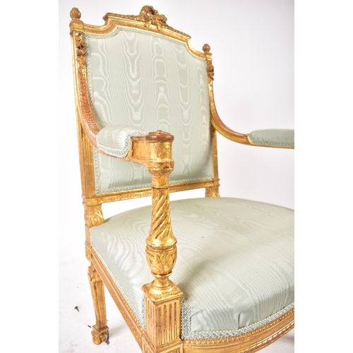 352 - A 19th century French Louis XVI gilt wood fauteuil bergere lounge armchair. The chair having a torch... 