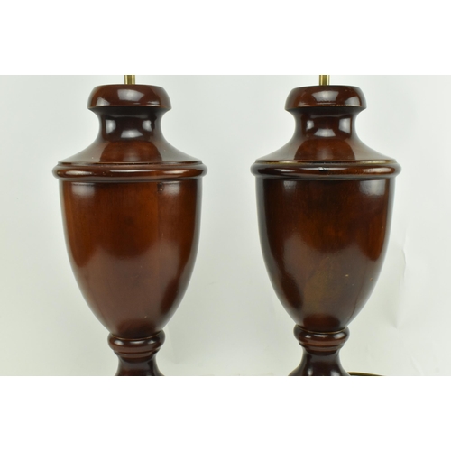 555 - A pair of turned wooden desk table lamps shades in the shape of urn in the manner of Porta Romana. E... 