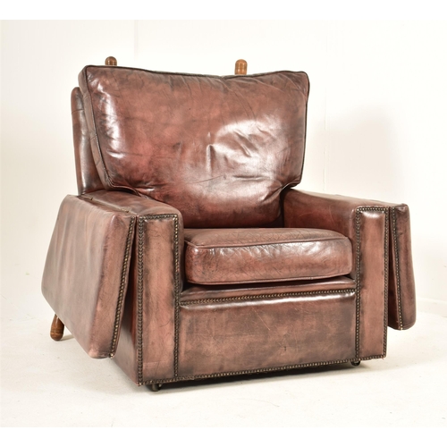 367 - A pair of Knole style brown leather drop-side armchairs. Each armchair having a straight back with w... 