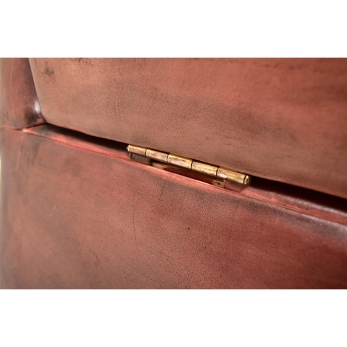 368 - A Knole style brown leather drop-side three seater sofa settee. The sofa having a straight back with... 