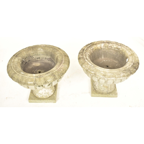 570 - A pair of green marble garden outdoor urn shaped planters. Each planter having a palmette motif ribb... 