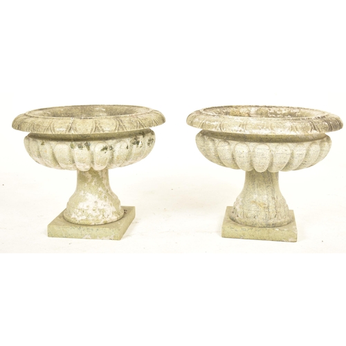 570 - A pair of green marble garden outdoor urn shaped planters. Each planter having a palmette motif ribb... 