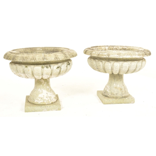 570 - A pair of green marble garden outdoor urn shaped planters. Each planter having a palmette motif ribb... 