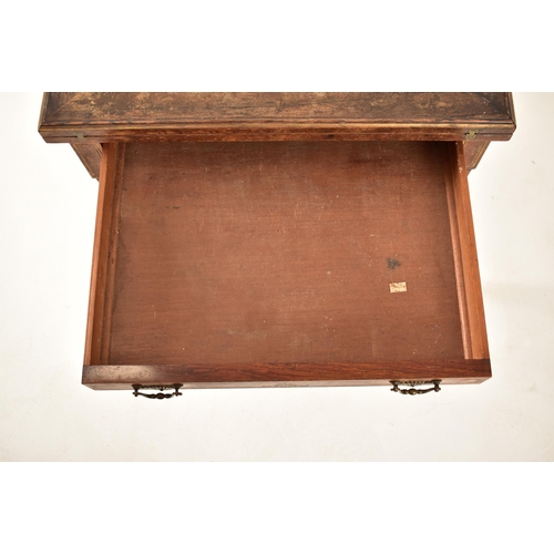 571 - An Edwardian oak & gilt detailed envelope card / game table. The table having a squared folding enve... 