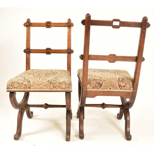 379 - A pair of late 19th century carved oak Gothic inspired Aesthetic Movement dining chairs. Each chair ... 