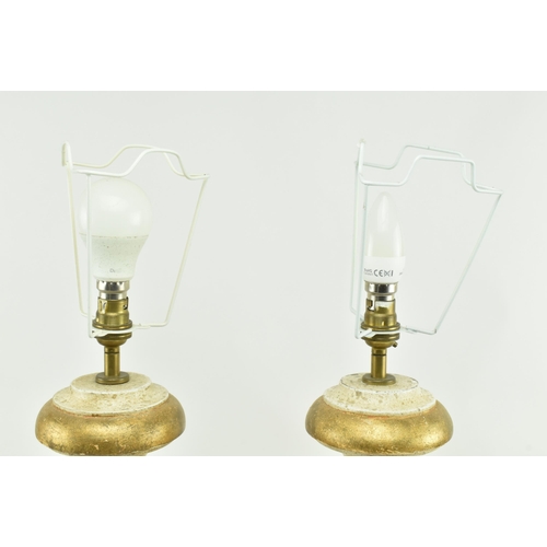 575 - Porta Romana - A pair of gold & cream aged effect wooden desk table lamps in the shape of urns. Each... 