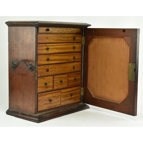 383 - An early 20th century mahogany watchmakers specimen chest cabinet. The cabinet having a chamfered fl... 