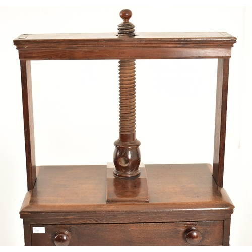 384 - A George III 18th century oak book press on table stand. The press having a large upright central wo... 