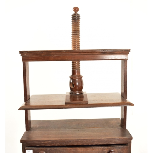 384 - A George III 18th century oak book press on table stand. The press having a large upright central wo... 