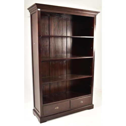 578 - A Victorian style 20th century mahogany open front bookcase. The bookcase having a cornice pediment ... 