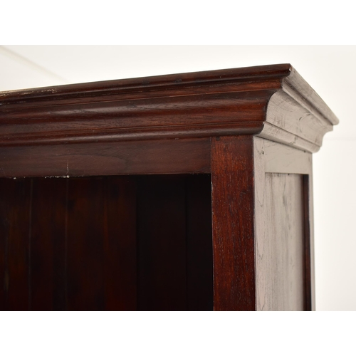 578 - A Victorian style 20th century mahogany open front bookcase. The bookcase having a cornice pediment ... 