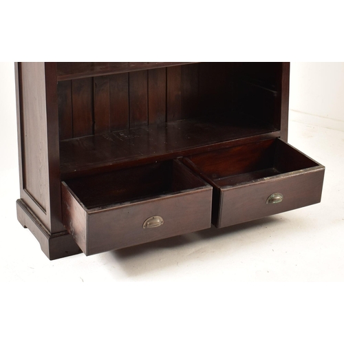 578 - A Victorian style 20th century mahogany open front bookcase. The bookcase having a cornice pediment ... 