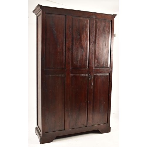 578 - A Victorian style 20th century mahogany open front bookcase. The bookcase having a cornice pediment ... 