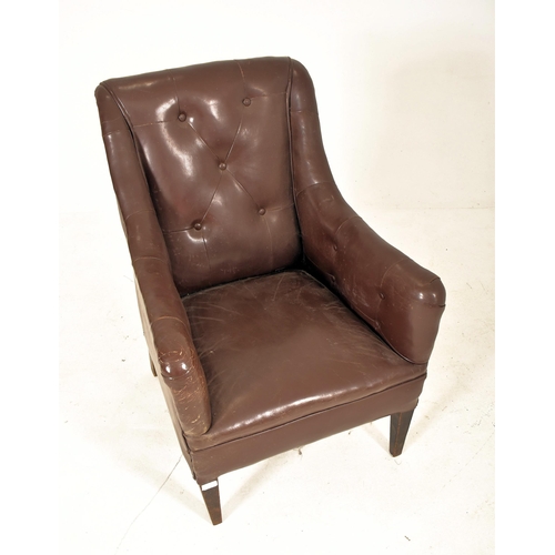 385 - A Victorian style 20th century brown leather button back Chesterfield armchair. The armchair having ... 