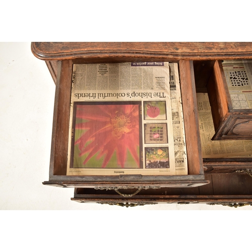 388 - A French 19th century oak commode / chest of drawers. The chest having a shaped top with chamfered e... 