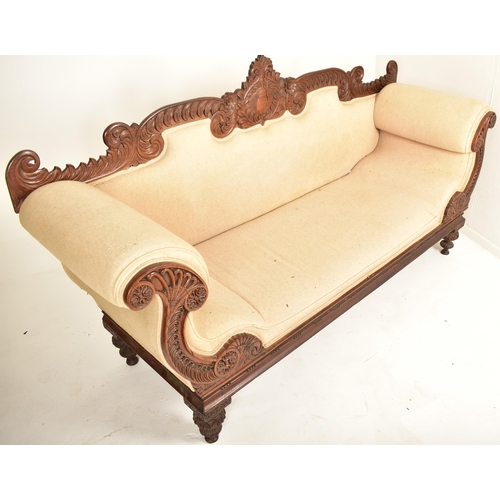 390 - A 19th century Anglo Colonial scroll ended chaise lounge / sofa settee. The chaise having a carved m... 