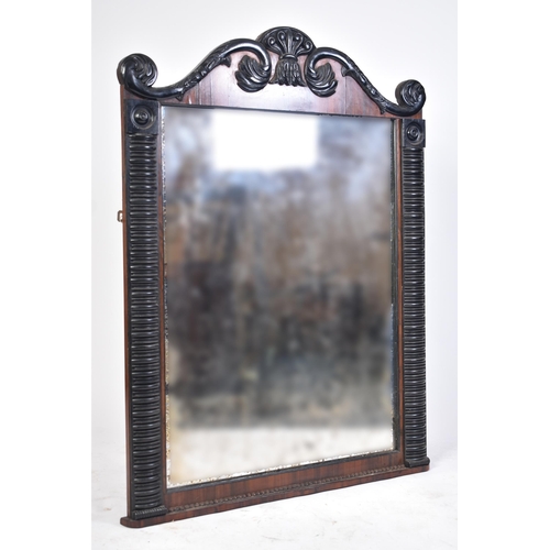 588 - A Regency period early 19th century ebonised wood & rosewood over mantle mirror. The mirror having a... 