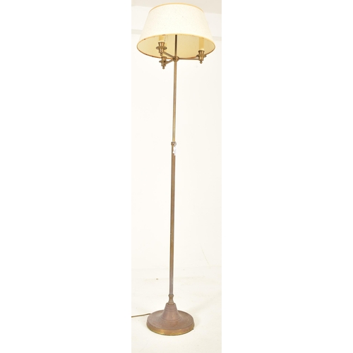 590 - A French inspired brass adjustable floor standard lamp. The lamp having a cream shade over three geo... 