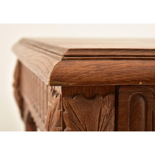 591 - A 19th century Continental Flemish / Dutch oak cup & cover writing table. The table having a chamfer... 