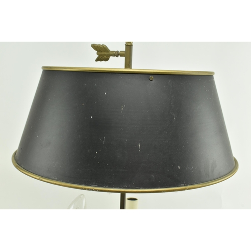 595 - A French brass bouillotte desk lamp light. The lamp having a garland shape carrying ring atop over a... 