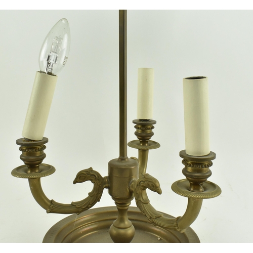 595 - A French brass bouillotte desk lamp light. The lamp having a garland shape carrying ring atop over a... 