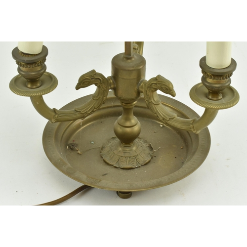 595 - A French brass bouillotte desk lamp light. The lamp having a garland shape carrying ring atop over a... 