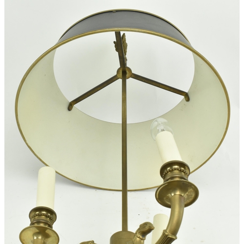 595 - A French brass bouillotte desk lamp light. The lamp having a garland shape carrying ring atop over a... 