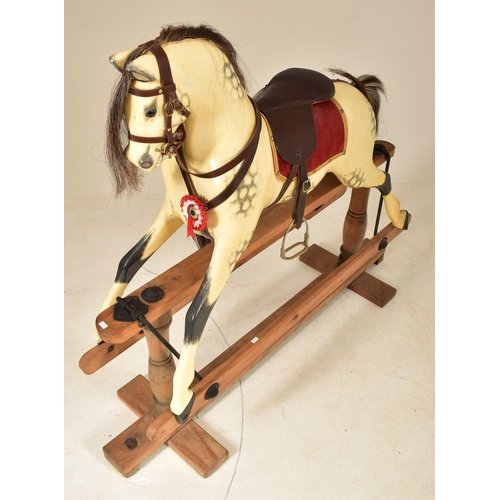 601 - G & J Lines Brothers - A vintage early 20th century rocking horse. The horse with hand painted finis... 