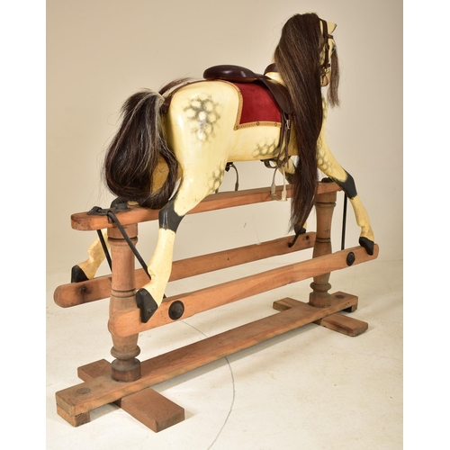 601 - G & J Lines Brothers - A vintage early 20th century rocking horse. The horse with hand painted finis... 