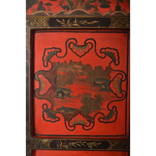 603 - An early 20th century Chinese four-fold black and red lacquered room divider / dressing screen. The ... 